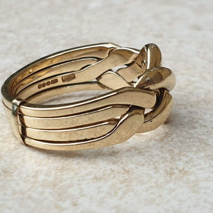 Four piece Puzzle Ring in 9ct Gold,  a UK P 1/2 or a US 8.