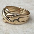 Four piece Puzzle Ring in 9ct Gold,  a UK P 1/2 or a US 8.