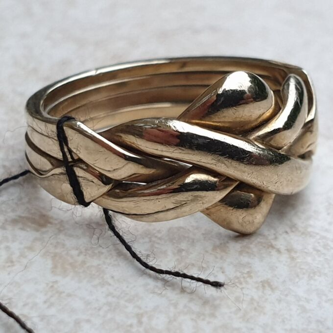 Four Piece Puzzle Ring in 9ct Gold, a UK N 1/2 or a US 7 1/2