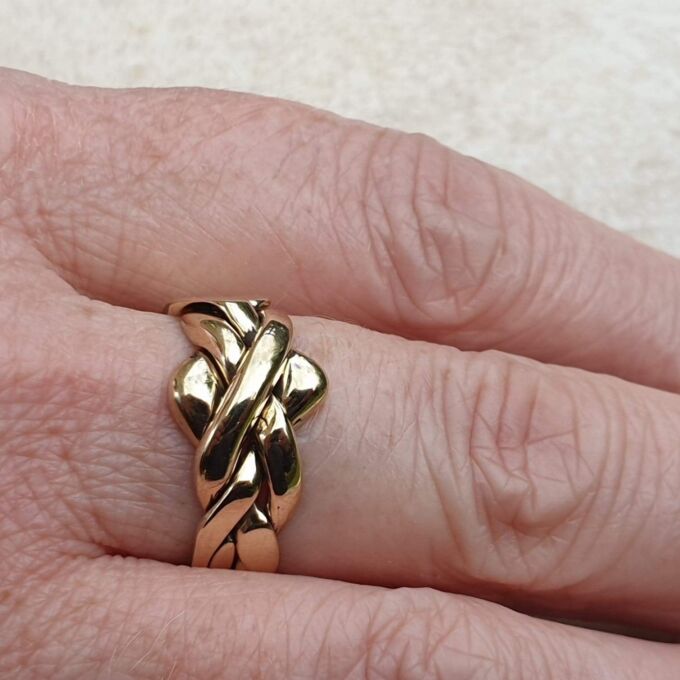 Four piece Puzzle Ring in 9ct Gold,  a UK P 1/2 or a US 8.