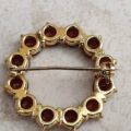 Garnet Twelve Stone Circular Brooch in 9ct Gold