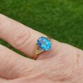 Oval Swiss Blue Topaz Ring in 10K Gold.