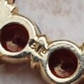 Garnet Twelve Stone Circular Brooch in 9ct Gold