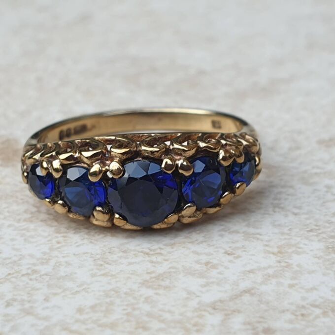 Vibrant Blue Five Stone Synthetic Sapphire Ring in 9ct Gold, a UK N or a US 7.