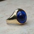 Synthetic Sapphire Cabochon Signet Ring in 9ct Gold, a UK P 1/2 or a US 8.