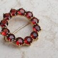 Garnet Twelve Stone Circular Brooch in 9ct Gold