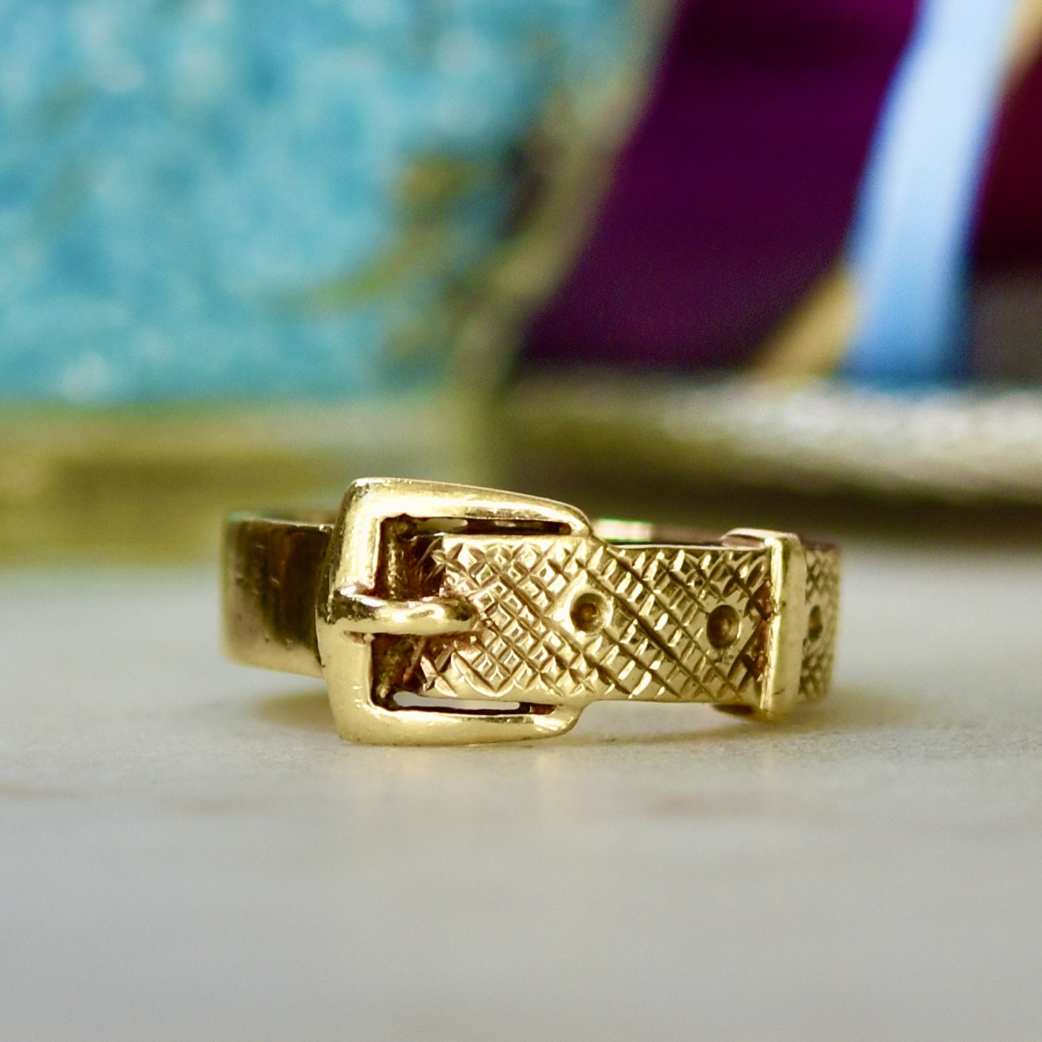 A wide gold buckle ring